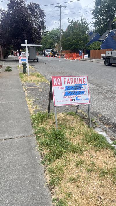 Construction equipment and no-parking signs along 45th Ave SW near the Fauntleroy Creek culvert replacement site