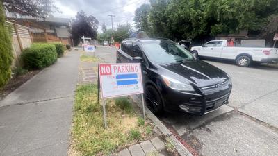 Temporary no-parking sign posted along 45th Ave SW for the culvert project